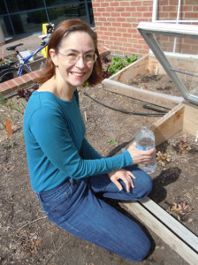 Kristin hand watering the garden