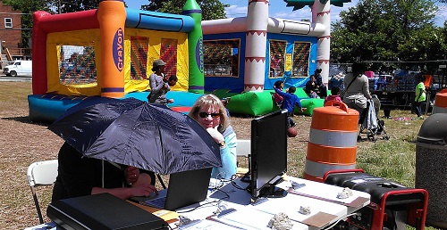 The Center for Local History’s Tad Suiter (under umbrella) and Judy Knudsen.